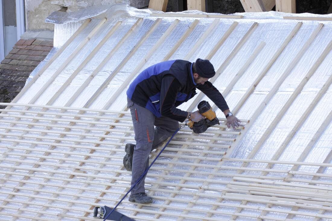 Roofers working on a low-slope roof