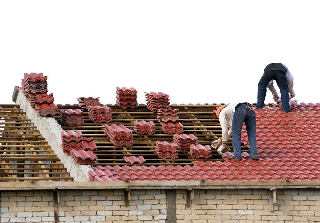 Tile roof work with underlayment visible